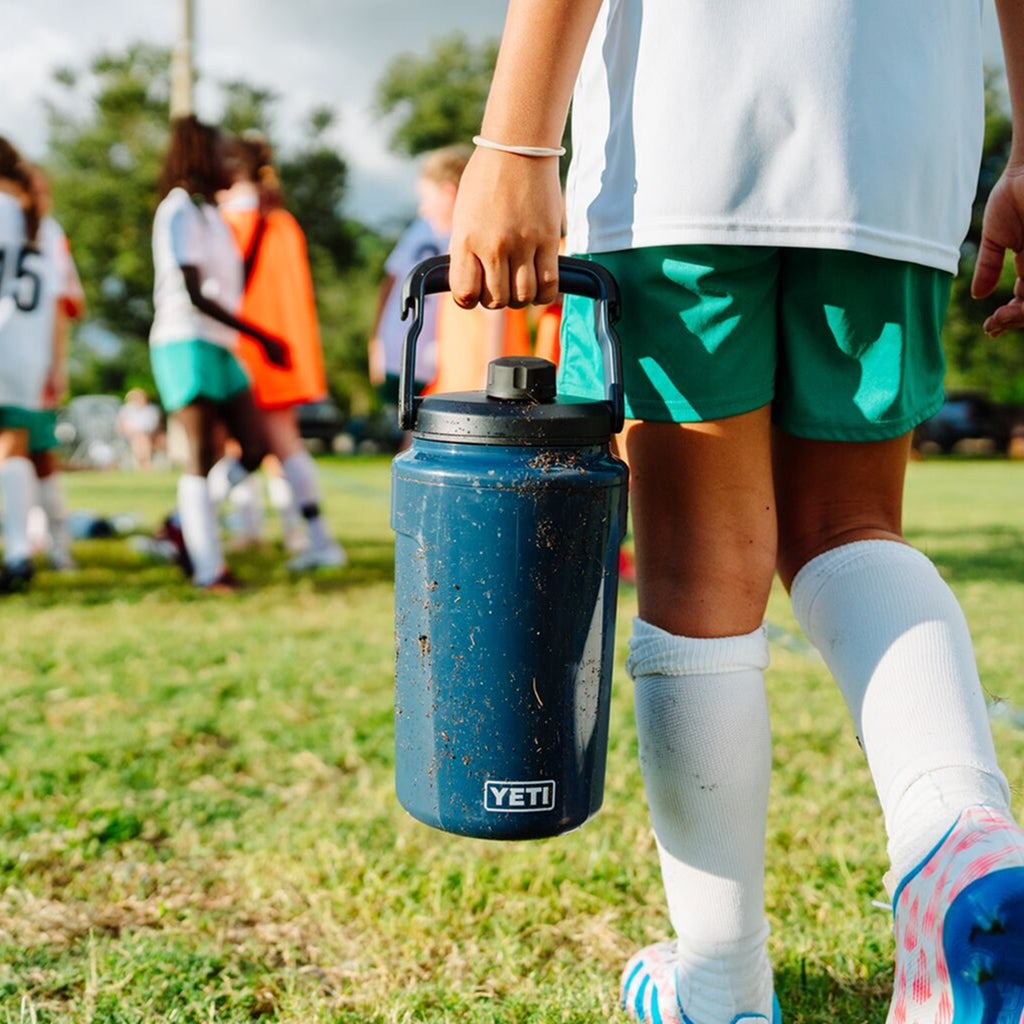 Football player carrying a Yeti Silo Jug.