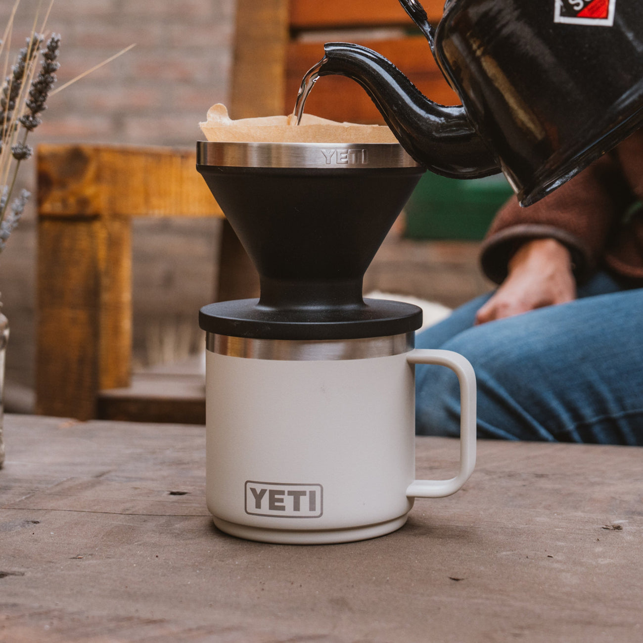 YETI mug with a pour over and black kettle on a wooden surface.